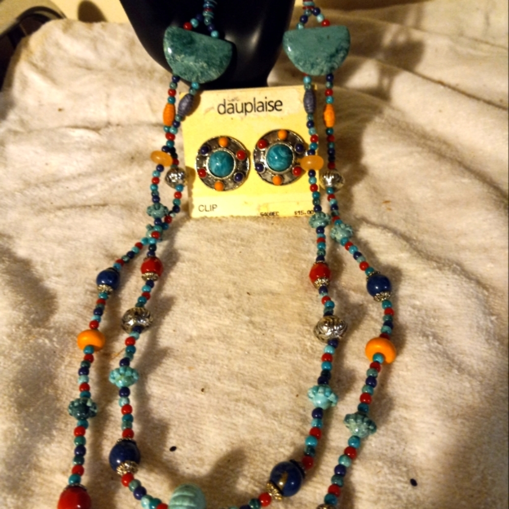 Used,not new multi colored  mainly plastic  2strand necklace& matching clip ons.